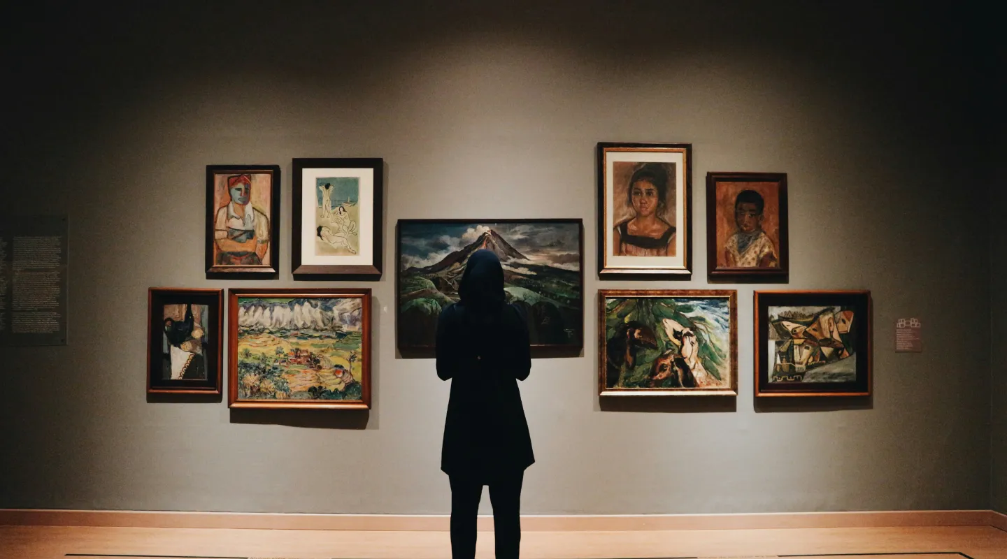 A happy window cleaner works on the windows of an old house