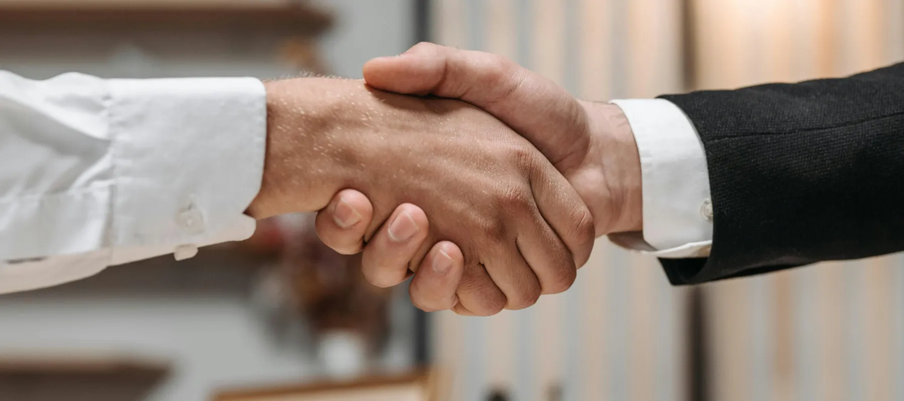 A happy window cleaner works on the windows of an old house
